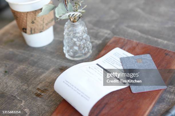 close-up of credit card and bill on table in rustic restaurant - restaurant bill ストックフォトと画像