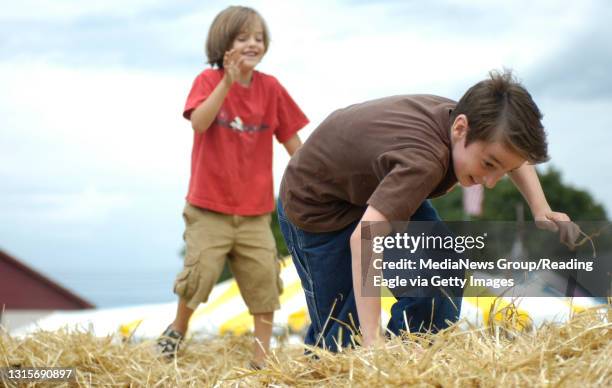 Photo by Lauren A. LittleJune 29, 2008Kutztown Festival Venice I. Colicchio of Kuztown, chases Clay S. Nelson of Decatur, Alabama, across hay bales...