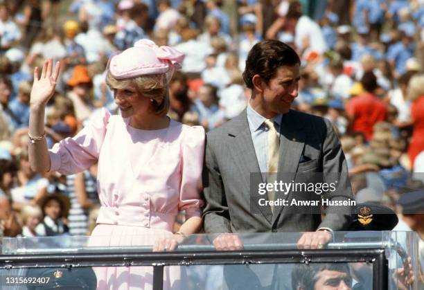 Prince Charles, Prince of Wales and Diana, Princess of Wales, wearing a pale pink dress designed by Catherine Walker with a matching archer style...