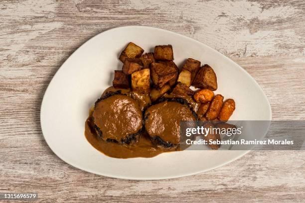 bull tail with red wine dish with fried potatoes. spanish tapas - bulls tail stock pictures, royalty-free photos & images
