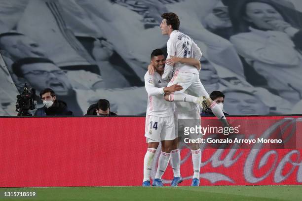 Carlos Casemiro of Real Madrid CF celebrates scoring their second goal with teammates Miguel Gutierrez and Alvaro Odriozola during the La Liga...