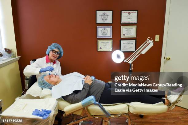 Kim Witwer, owner of La'Derma performs microneedling on Kim High, of Rockland Township, inside the business. Photo by Natalie Kolb