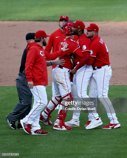 Amir Garrett of the Cincinnati Reds is restrained by teammates during a bench clearing incident in the eighth inning against the Chicago Cubs at...