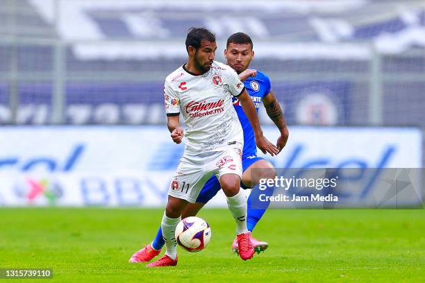 Junior Sornoza of Tijuana fights for the ball with Juan Escobar of Cruz Azul during the 17th round match between Cruz Azul and Tijuana as part of the...