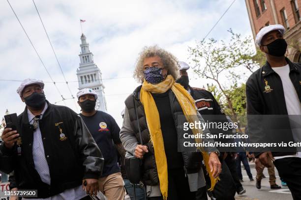 Social justice icon Angela Davis flanked by ILWU Local 10 union members at the May Day demonstrations along Market Street, Saturday, May 1 in San...