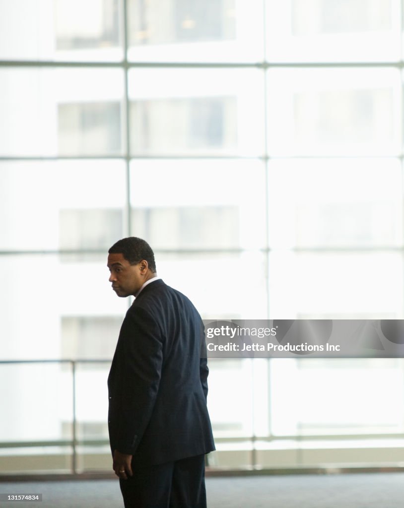 African American businessman standing in lobby