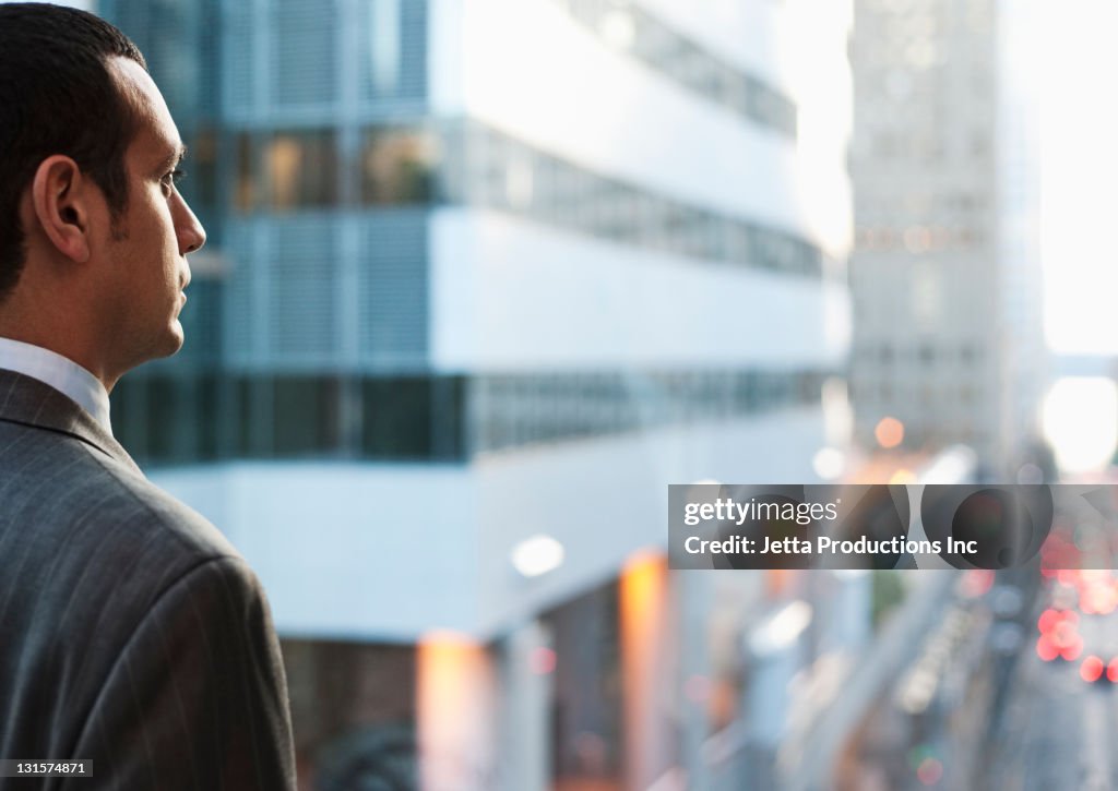 Hispanic businessman looking at city scene