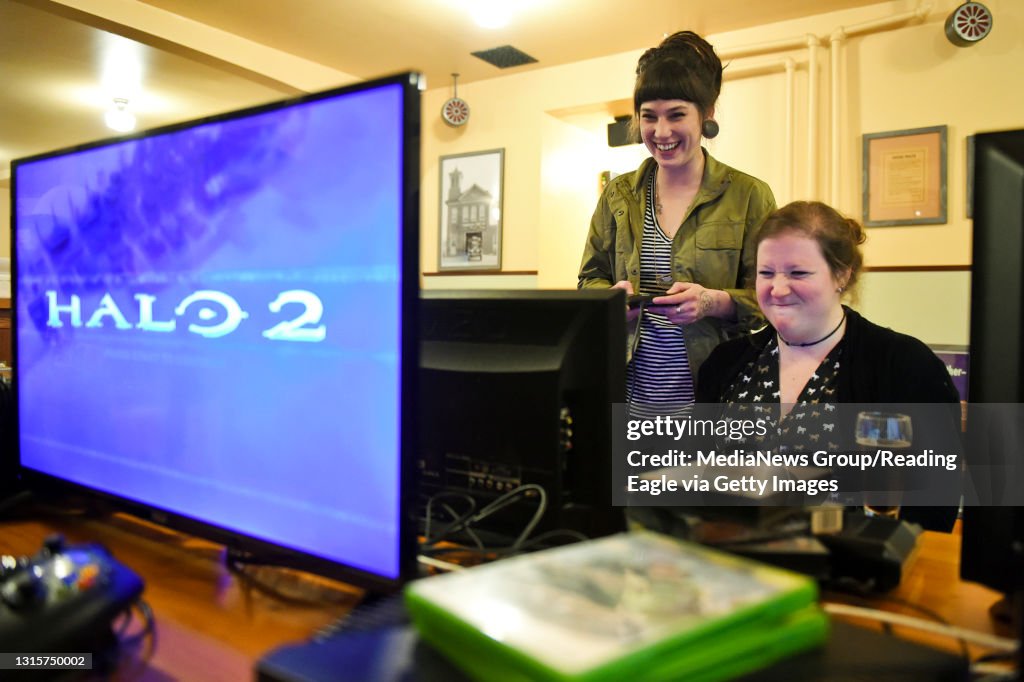 Iris Rinker of Reading helps Amanda Mellinger play Streets of Rage II on a Sega Genesis inside Oakbrook Brewing Company on Tuesday, February 27, 2018. Photo by Natalie Kolb