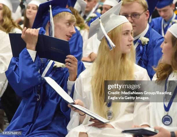 Dawson Gabriel Christ and Cecilia Eve Clay compare their diplomas with some of their classmates. The 112th Annual Commencement ceremonies were held...