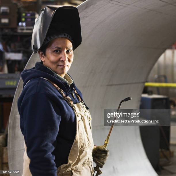 mixed race welder in factory - blue collar worker mask stock pictures, royalty-free photos & images