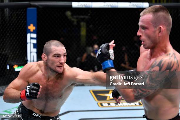 Sean Strickland punches Krzysztof Jotko of Poland in a middleweight bout during the UFC Fight Night event at UFC APEX on May 01, 2021 in Las Vegas,...