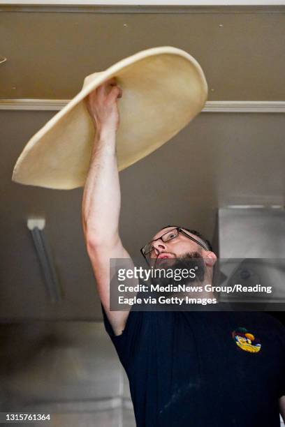 Antonio D. Lavigna, manager at Paradise by the Slice, tosses pizza dough into the air inside the kitchen on Tuesday, April 3, 2018. Photo by Natalie...