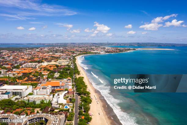 dramatic aerial view of the famous kuta beach in bali, indonesia - denpasar stockfoto's en -beelden