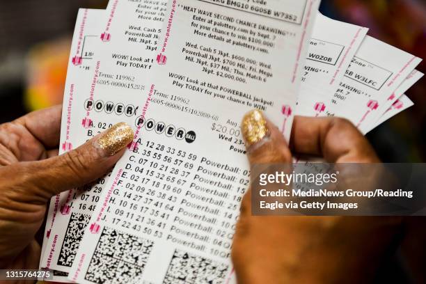 Doris Natal of Reading checks out her 126 Powerball tickets as part of a pool with the Berks County Sheriff's Office at the Sunoco in Exeter. Photo...