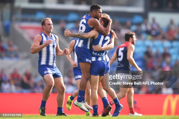 Tarryn Thomas of the Kangaroos congratulates Jy Simpkin of the Kangaroos during the round seven AFL match between the North Melbourne Kangaroos and...