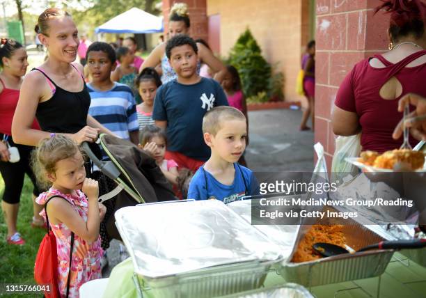 People wait in line for food during Peace on the Streets Back to School Drive at the 11th and Pike playground. Photo by Natalie Kolb 8/13/2016