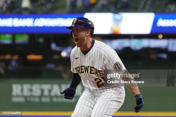 Travis Shaw of the Milwaukee Brewers celebrates after driving in the winning run during the eleventh inning against the Los Angeles Dodgers at...