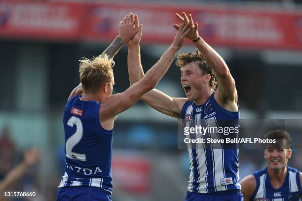 Nick Larkey of the Kangaroos celebrates a goal with Jaidyn Stephenson of the Kangaroos during the round seven AFL match between the North Melbourne...