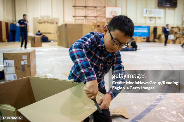 Pop Up Cardboard Playground at Third and Spruce Rec Center Ethan Zhou Spring Township, is busy make a game that will involve a tennis ball to bounce...