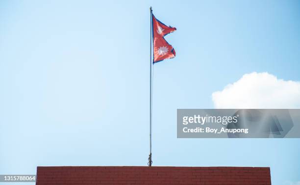 the national flag of nepal on the pole. - nepali flag stock-fotos und bilder