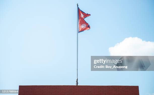 the national flag of nepal on the pole. - nepali flag stockfoto's en -beelden