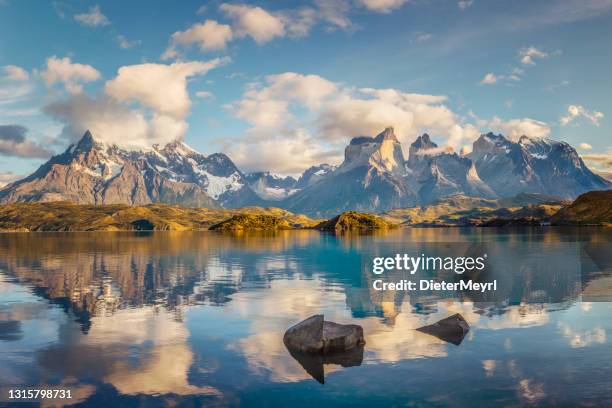 blue lake on a snowy mountains background and cloudy sky torres del paine - patagonia chile stock pictures, royalty-free photos & images
