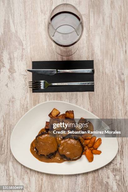 bull tail with red wine dish with fried potatoes. spanish tapas - fried oxtail soup stock pictures, royalty-free photos & images