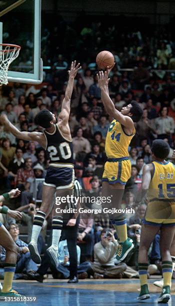 Forward Adrian Dantley of the University of Notre Dame Fighting Irish shoots the basketball as guard Levi Phillips of the West Virginia University...