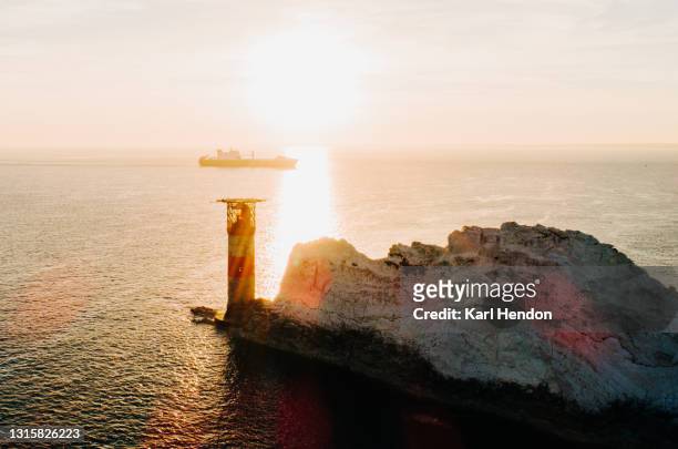 an aerial sunset view of the needles lighthouse, isle of wight - stock photo - isle of wight needles stock pictures, royalty-free photos & images