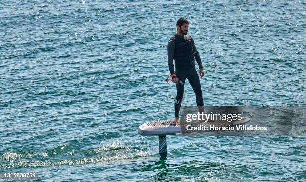 Surfer sails on a Waydoo Flyer ONE electric powered board in the Bay of Cascais on the day it ends the state of emergency during the COVID-19...