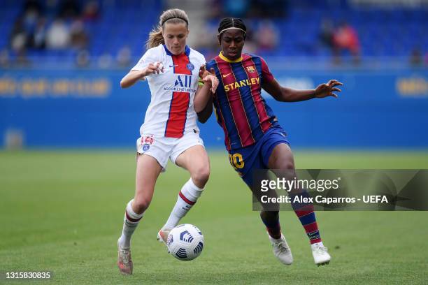 Irene Paredes of Paris Saint-Germain battles for possession with Asisat Oshoala of FC Barcelona during the UEFA Women's Champions League Semi Final...