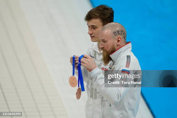Evgenii Kuznetsov and Nikita Shleikher of Russia pose with their bronze medals after a medal ceremony for the Men's 3m Synchro Springboard final on...