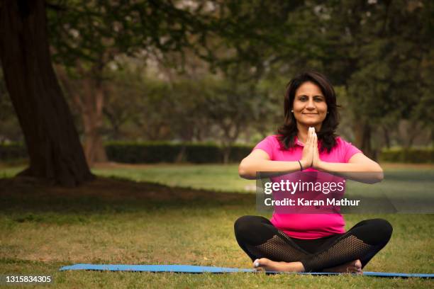 lady doing yoga in park stock photo - yoga day stock pictures, royalty-free photos & images