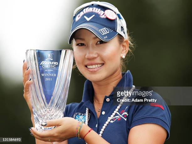 Momoko Ueda of Japan celebrates victory with the trophy after the 3rd playoff hole in the final round of the Mizuno Classic at Kintetsu Kashikojima...