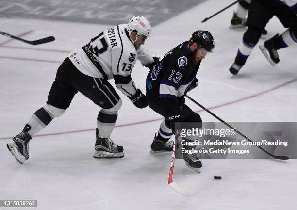 Reading forward Olivier Labelle controls the puck in front of Manchester forward Gasper Kopitar .Reading Royals lose 5-1 to the Manchester Monarchs...