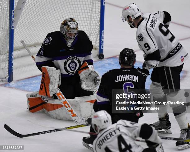 Reading goalie Martin Ouellette makes a save on Manchester defenseman Teddy Doherty in front of Manchester forward Kevin Morris .Reading Royals lose...