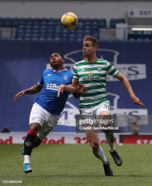 Alfredo Morelos of Rangers vies with Kris Ajer of Celtic during the Ladbrokes Scottish Premiership match between Rangers and Celtic at Ibrox Stadium...