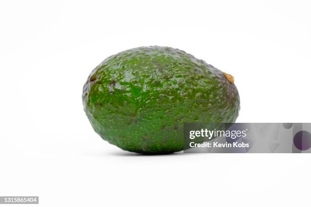 front view of lying avocado. - avocado isolated stock-fotos und bilder