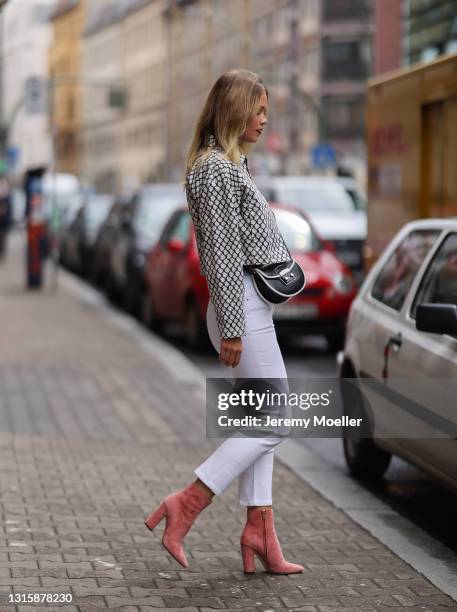 Melanie Kroll wearing black and white Furla bag, white Tommy Hilfiger jeans, black and white Longchamp jacket and black top and Jimmy Choo boots on...