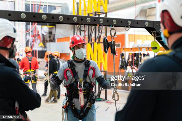 instructor explaining the theoretical part to his students in working at height education - protective sportswear stock pictures, royalty-free photos & images