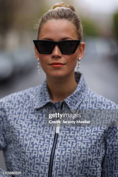 Melanie Kroll wearing black H&M shades and Longchamp logo jeans jacket on April 29, 2021 in Berlin, Germany.