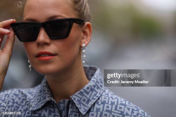 Melanie Kroll wearing black H&M shades and Longchamp logo jeans jacket on April 29, 2021 in Berlin, Germany.