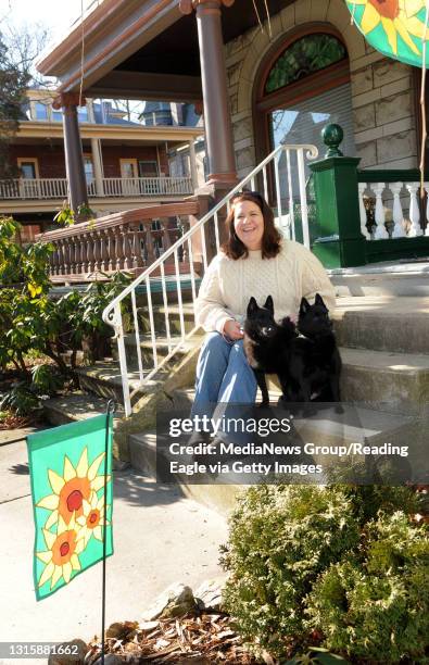 Michele Kundrack sits on the front stoop of her home in Centre Park with her two Schipperkes. Susan L. Angstadt 1/23/10