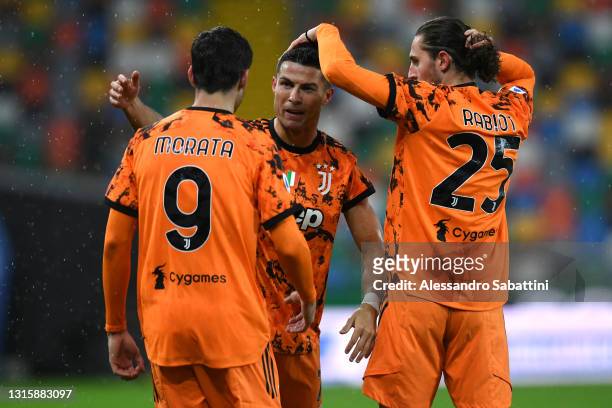 Cristiano Ronaldo of Juventus celebrates with team mates Alvaro Morata and Adrien Rabiot after scoring their side's second goal during the Serie A...