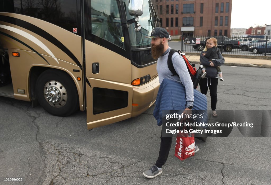 Royals player Mark Dekanich walks to the bus with his wife Elizabeth, and son Ascher, 19 months. Elizabeth and Ascher came out to see him off. Reading Royals hockey players board the bus on Grace Street in Reading Wednesday afternoon April 11, 2018 for th