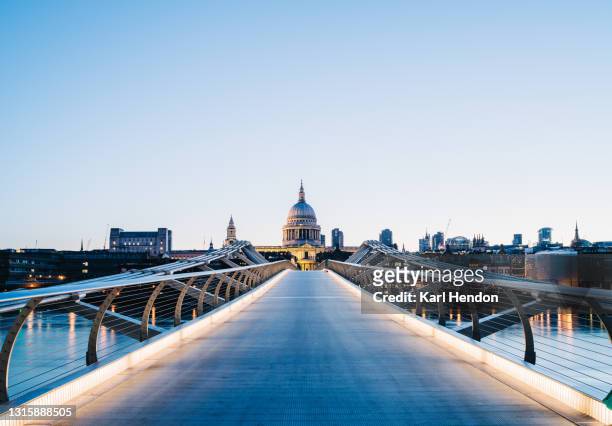 a surface level view of st.paul's cathedral and the millennium bridge at sunrise - stock photo - london bridge stock pictures, royalty-free photos & images