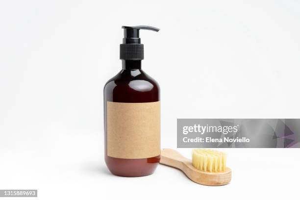 composition with bottles cleansing moisturizer and brush for skin cleansing and massage. natural cosmetics for skincare, body and hair care - shampoo imagens e fotografias de stock