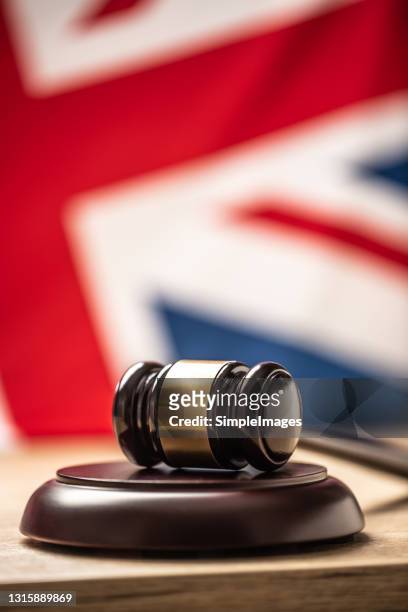 judges wooden hammer in front uk flag. - england slovakia stock pictures, royalty-free photos & images