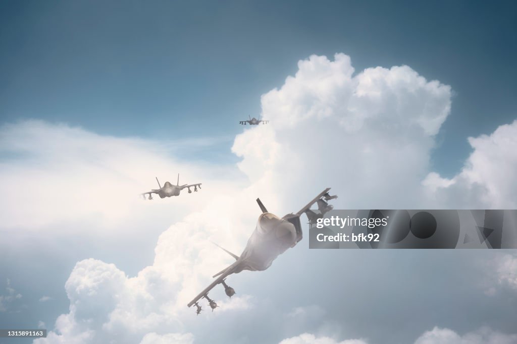 Jet fighters flying over clouds.