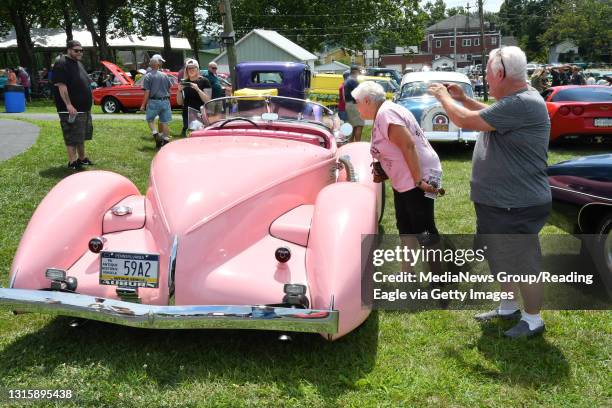 Linda and Tim Wismer of Douglassville examine the 1935 Auburn Speedster owned by Vaughn Skoog of Pike Township at the Cruise Night portion of the...